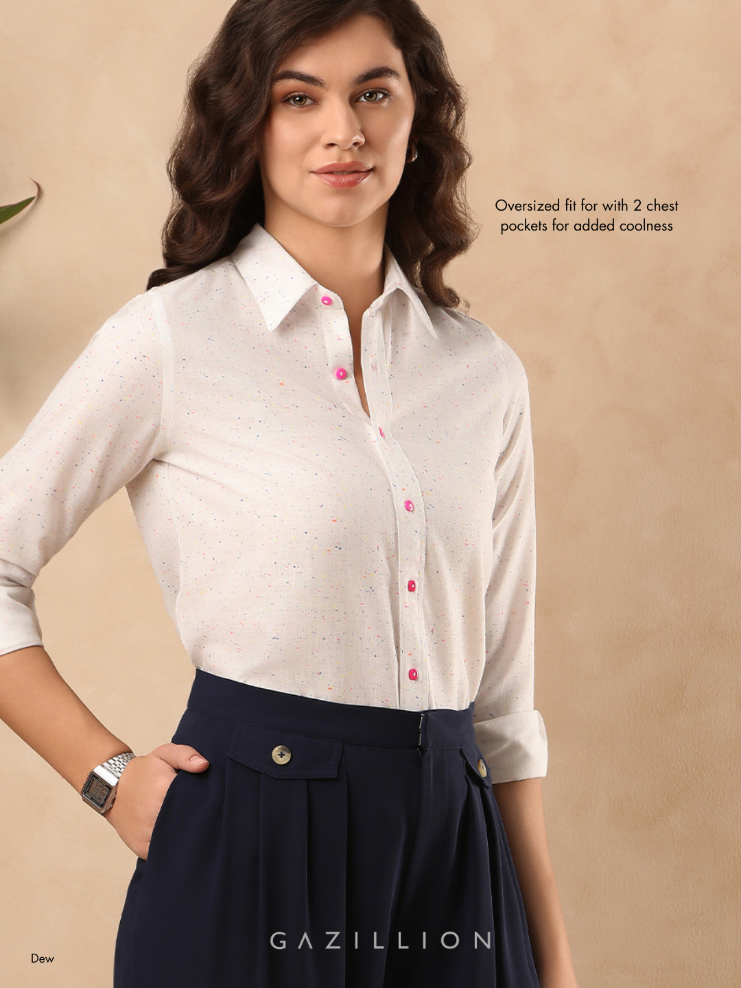 Woman wearing a white shirt with pink buttons and navy skirt on a beige background