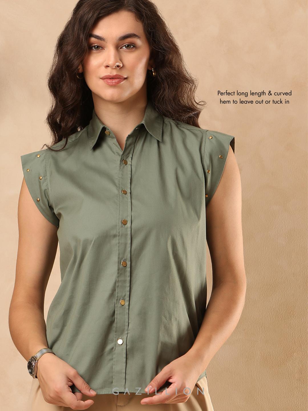 Woman wearing a green sleeveless shirt against a beige background