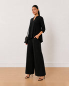 Alda black 100% viscose loose top, angled front view with the boxy fit
