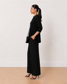Alda black viscose loose top side profile with the extended shoulders