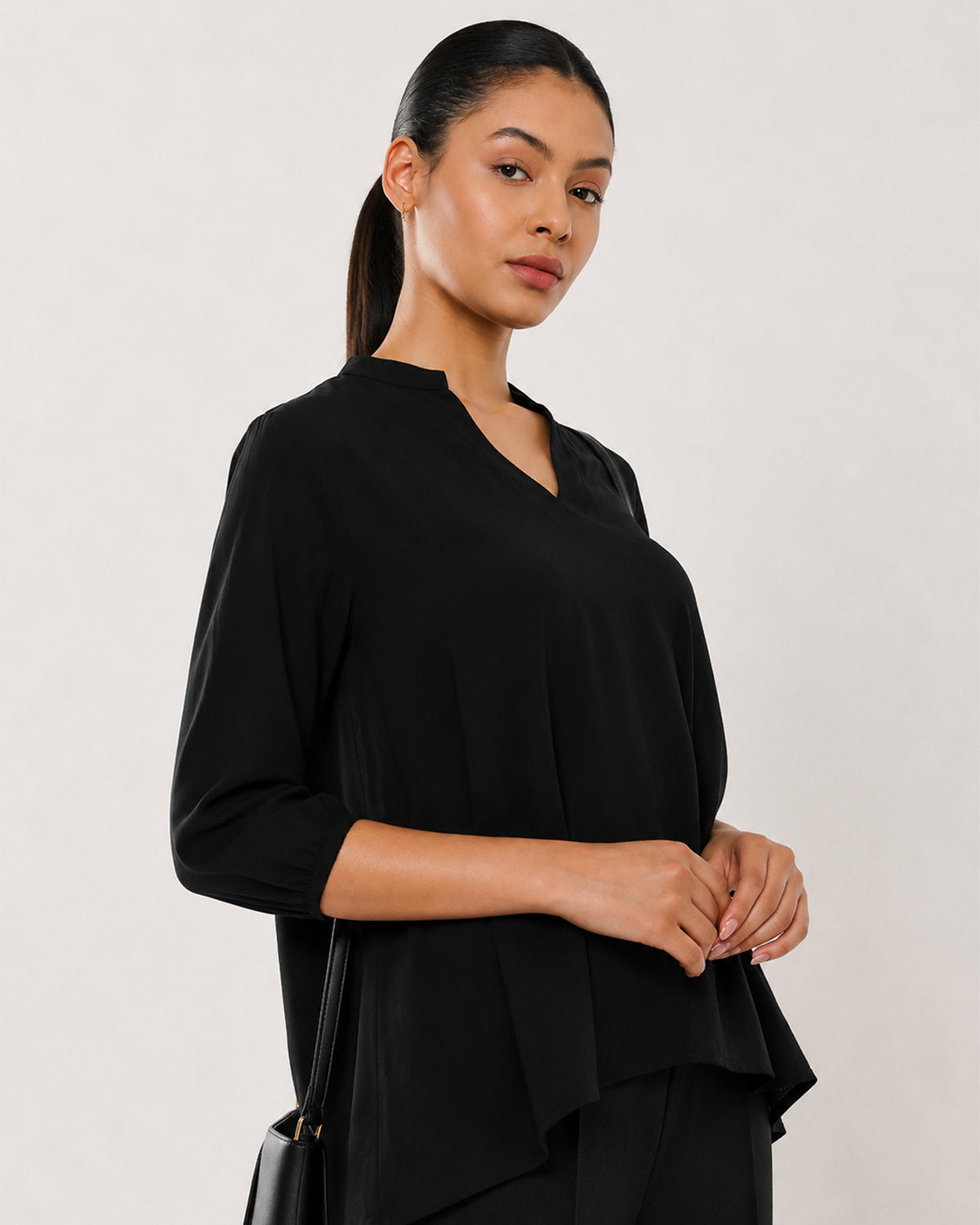 Alda black viscose top waist up view with the 3/4th sleeves and boxy silhouette