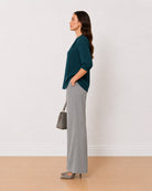 Alda bottle green viscose loose top side profile with the long curved hem