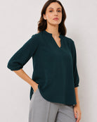 Alda bottle green viscose top waist up front with the 3/4th sleeves and curved hem