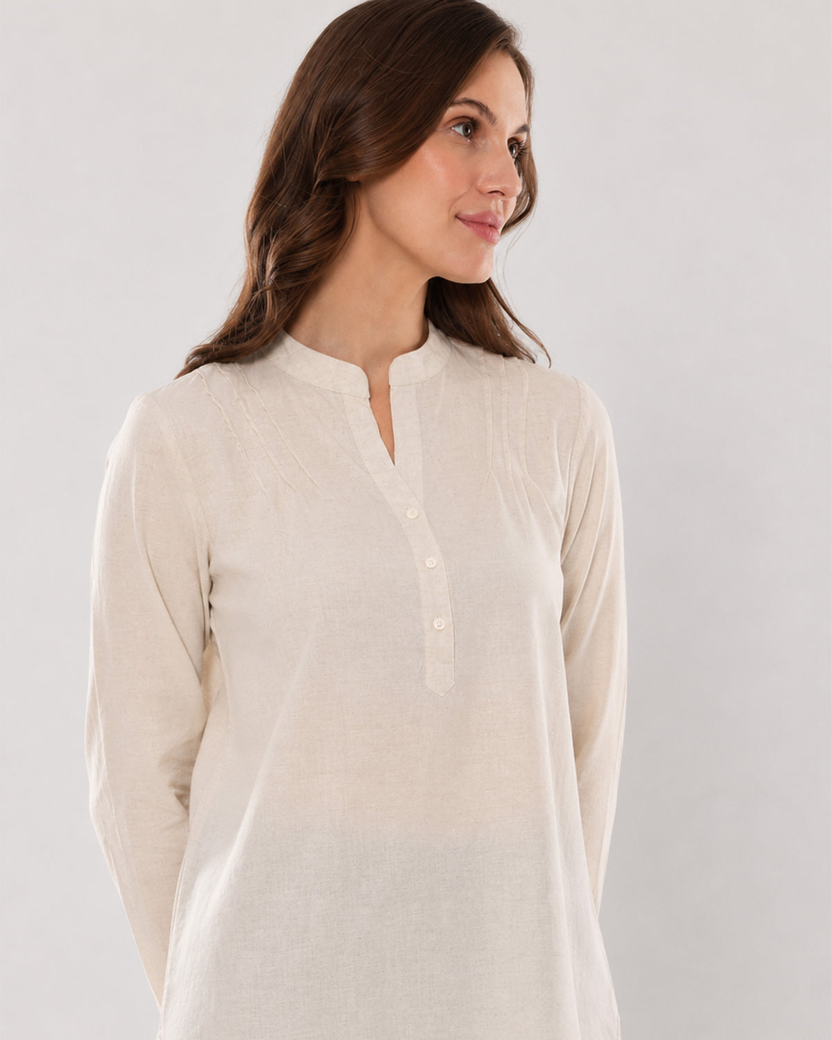 Alexa beige cotton linen tunic shirt, angled waist up view of the relaxed tunic fit