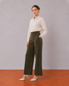 Alexis beige cotton linen shirt, angled view with the long length and curved hem