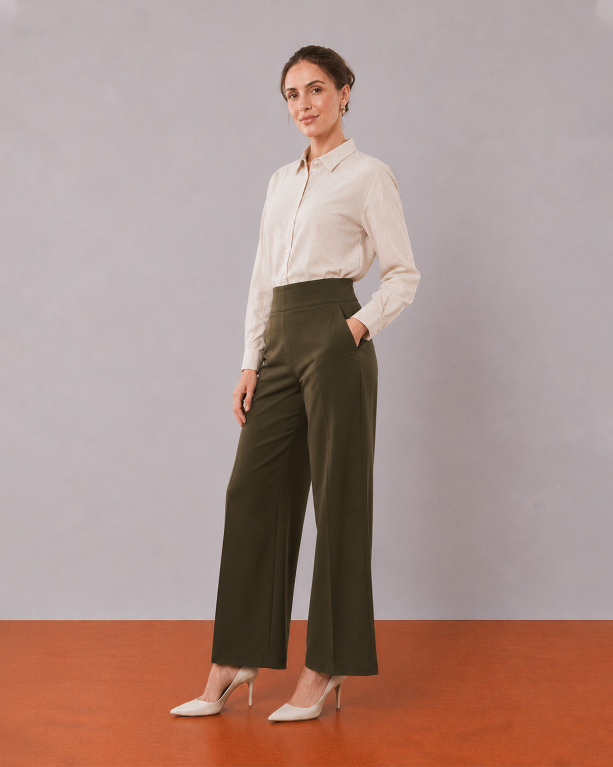 Alexis beige cotton linen shirt, angled view with the long length and curved hem