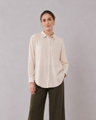 Alexis beige cotton linen shirt waist up front with the long curved hem