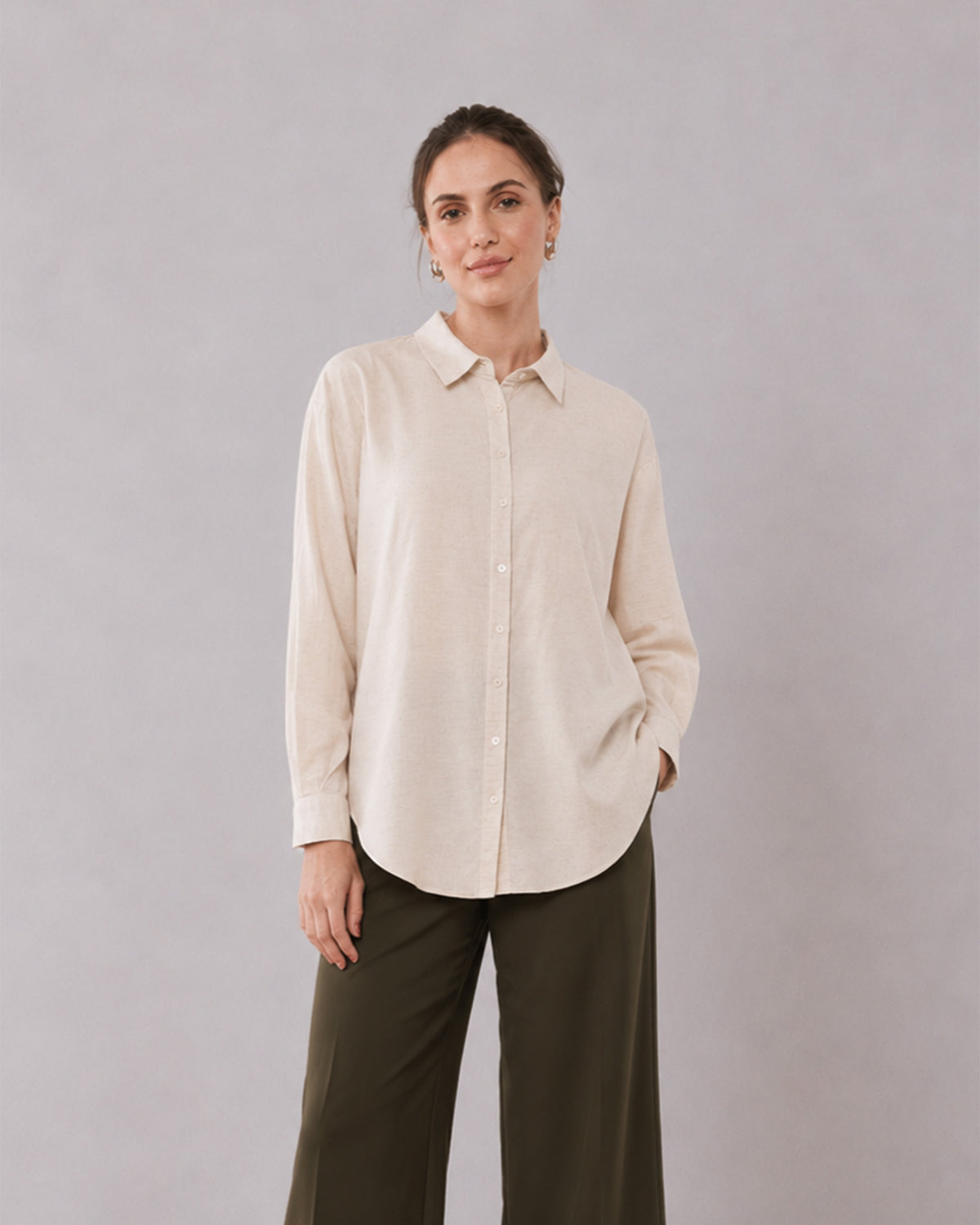 Alexis beige cotton linen shirt waist up front with the long curved hem