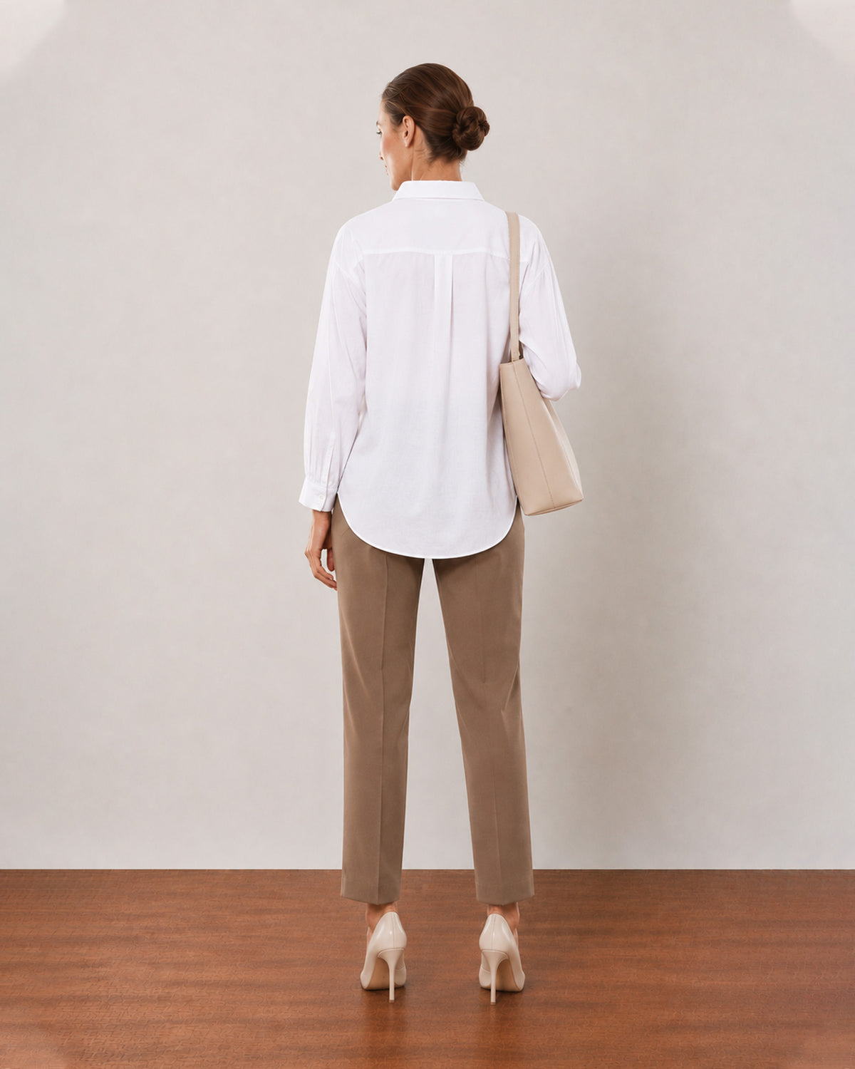 Alexis white cotton linen shirt back view with the long length and curved hem