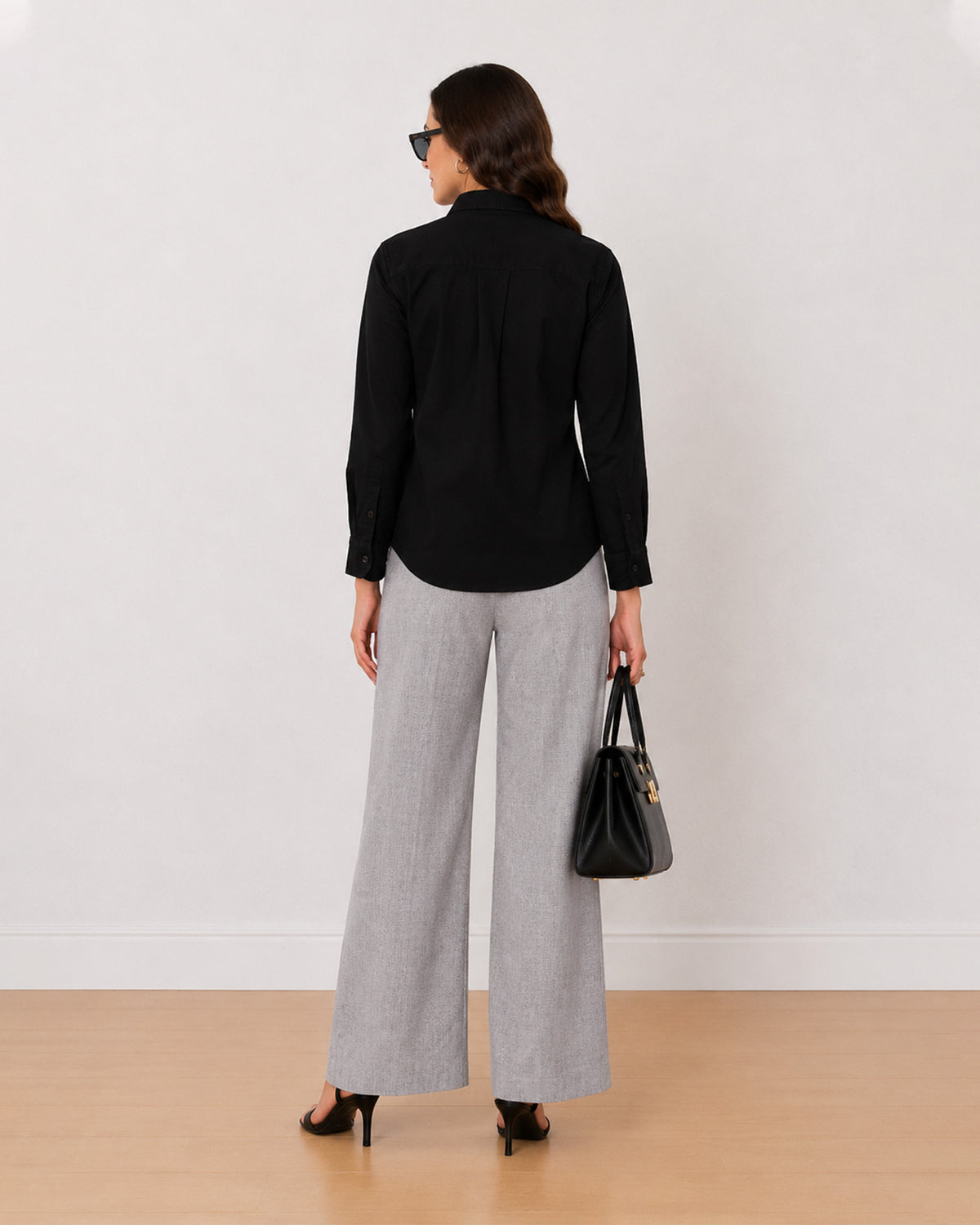 Allaya black denim utility shirt back view with the long length and curved hem