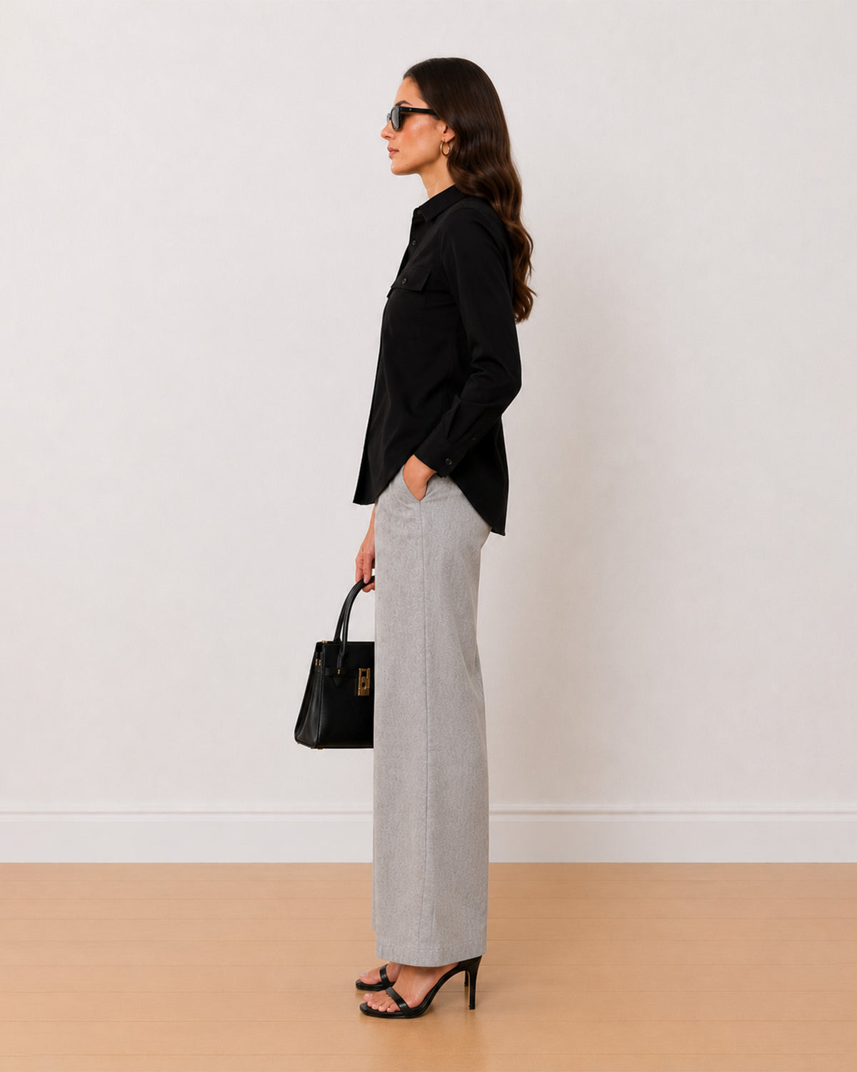 Allaya black denim utility shirt side profile with the curved hem