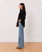 Allison black denim longline shirt side profile with the inseam side pockets