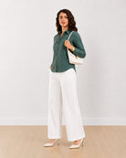 Analia bottle green corduroy utility shirt, angled view with the 2 utility pockets