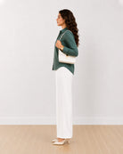 Analia bottle green corduroy utility shirt side profile with the curved hem