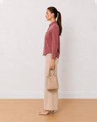 Analia onion pink corduroy utility shirt side profile with the curved hem