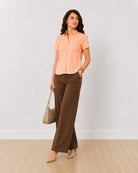 Ariana peach cotton half sleeves shirt on the move, front view with curved hem