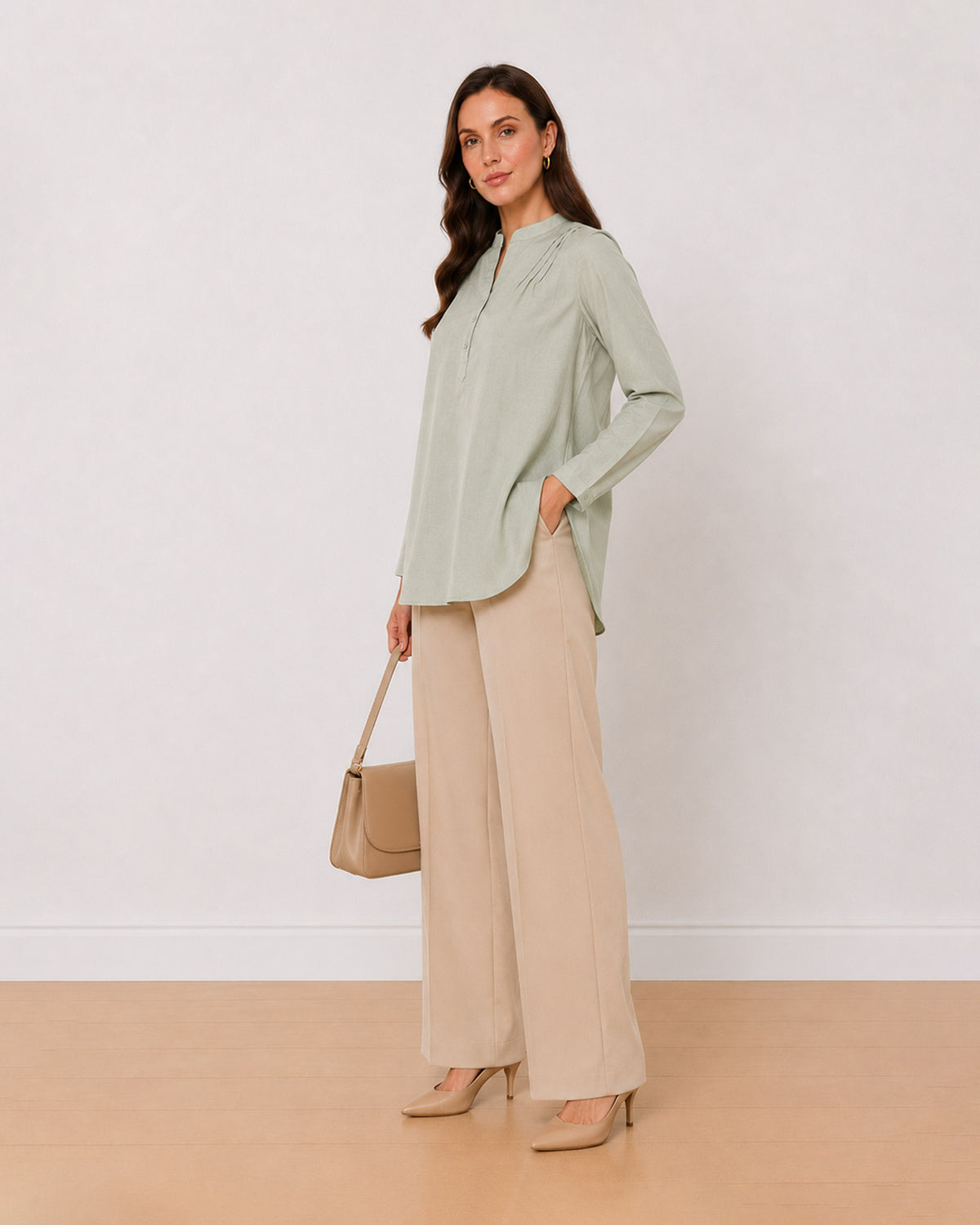 Audrey sage green textured cotton tunic shirt, angled view with the curved hem