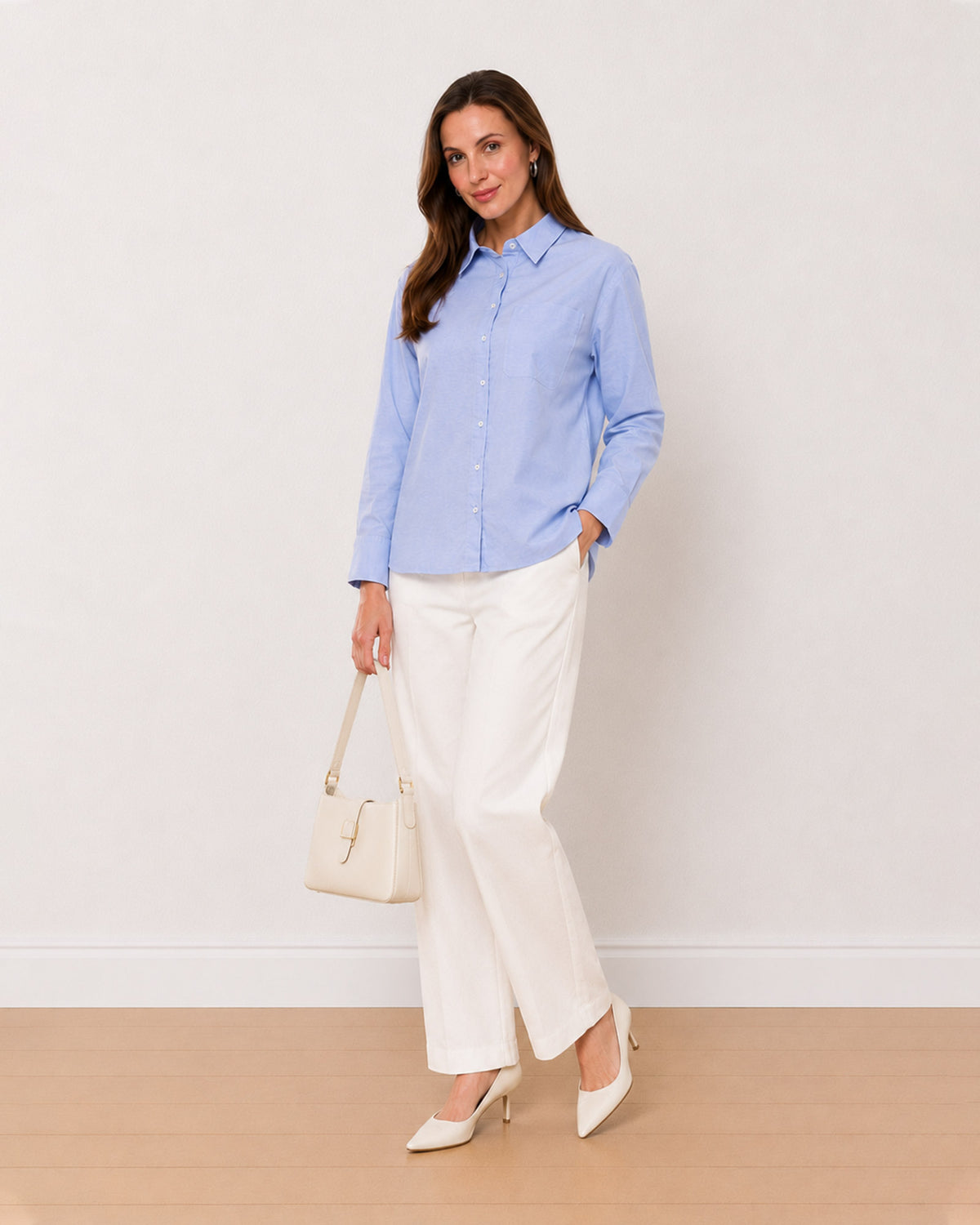 Ava sky blue Oxford cotton oversized shirt, angled front view with patch pocket