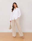 Ava white Oxford cotton oversized shirt, angled front view with the patch pocket
