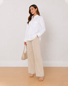 Ava white 100% Oxford cotton oversized shirt, angled view with the curved hem