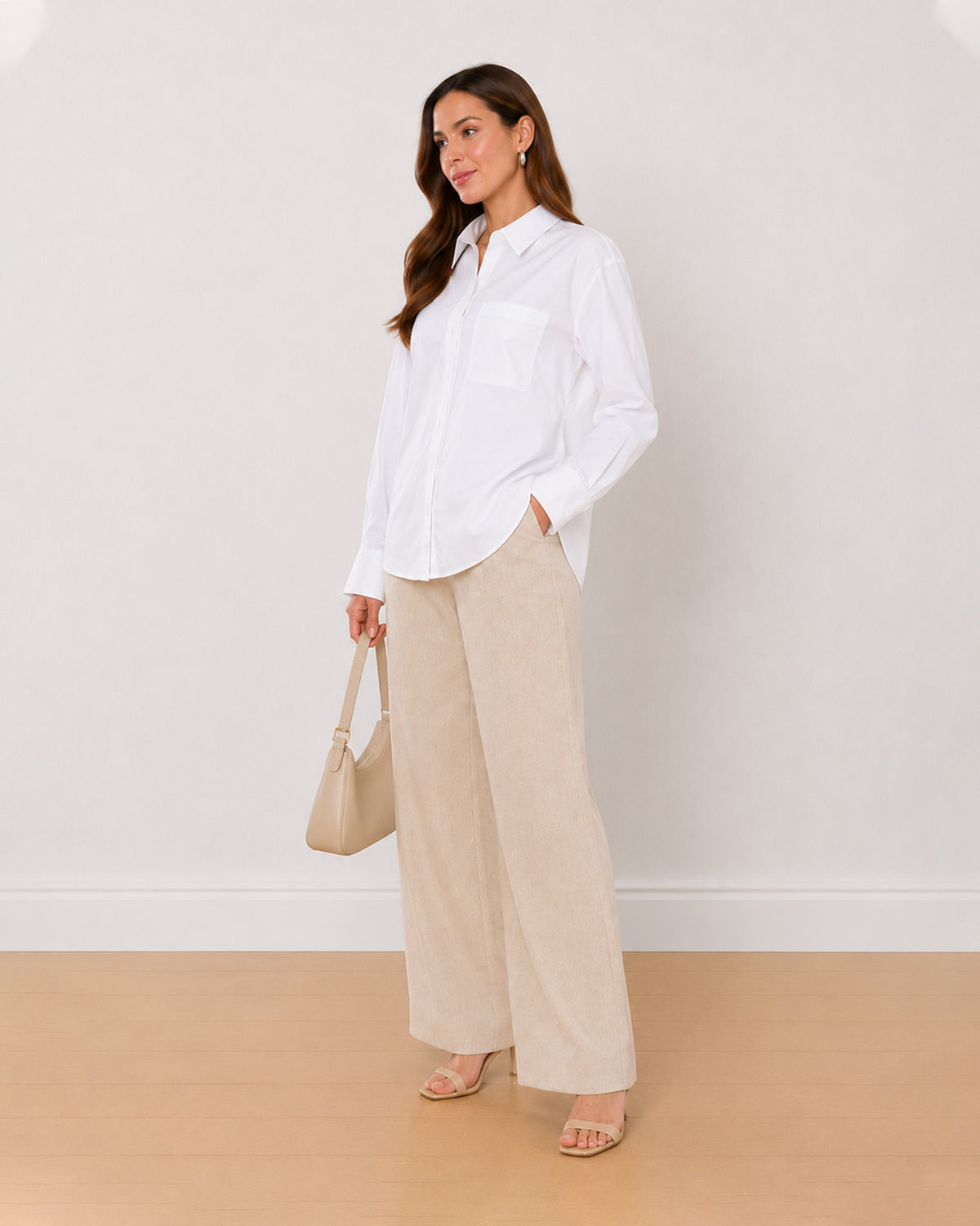 Ava white 100% Oxford cotton oversized shirt, angled view with the curved hem