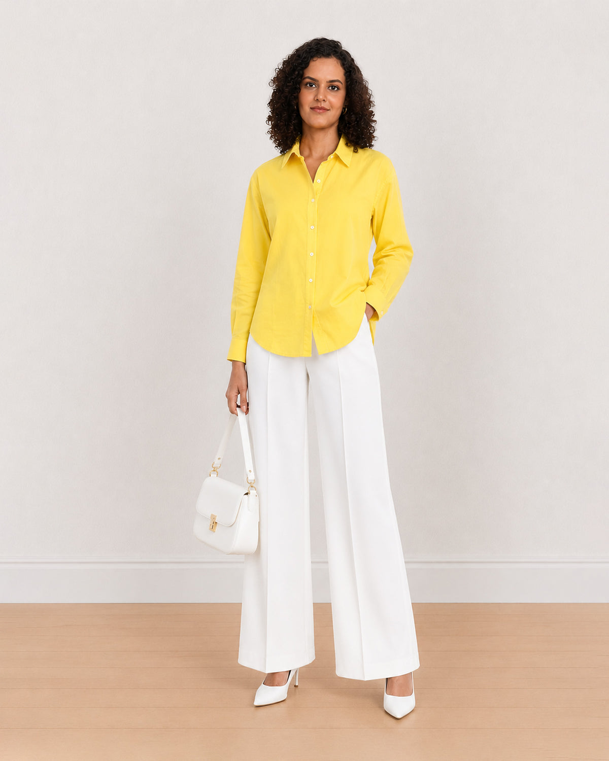 Bali bright yellow cotton poplin shirt worn loose, front view with the long curved hem