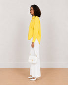 Bali bright yellow 100% cotton shirt side view with the long length and curved hem