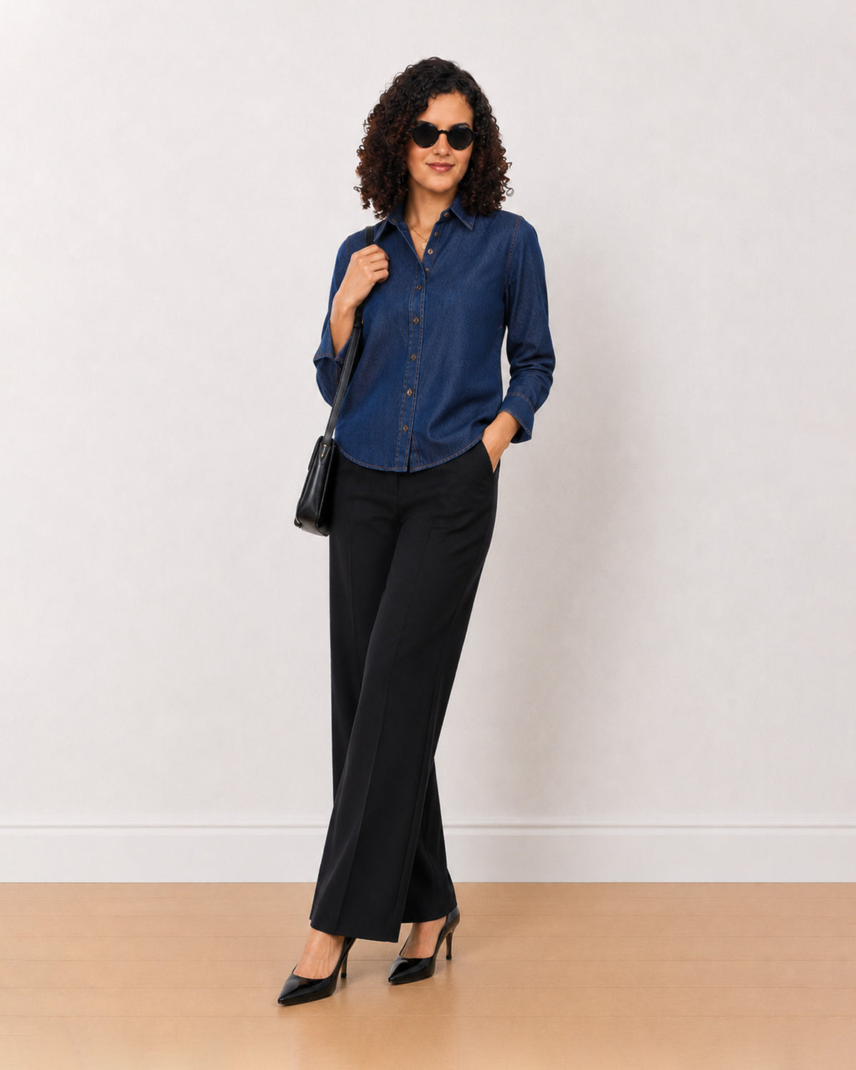 Banita medium blue denim shirt worn loose, front view with the long curved hem