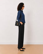 Banita medium blue denim shirt side view with the long length and curved hem