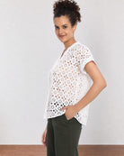Belinda white schiffli lace top, angled front view with boxy fit and extended shoulders