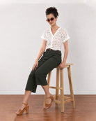 Belinda white schiffli cutwork lace top, seated full length view with stand collar