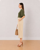 Bella beige medium waist 3/4th straight pants, side view with the mid calf hem