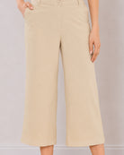 Bella beige pants waistband close-up with button and zip opening and side cross pocket