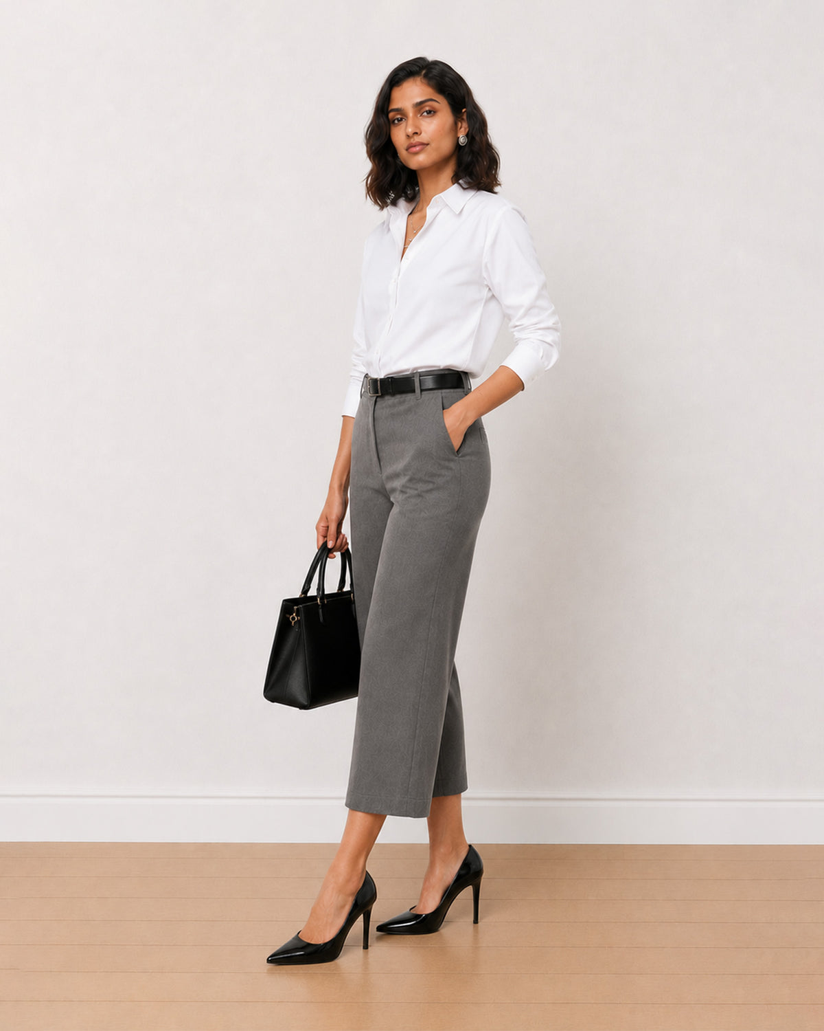 Bella grey 3/4th straight pants front view with a hand in the side cross pocket