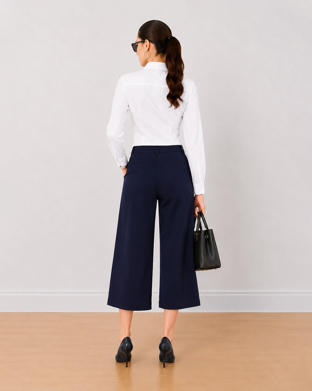 Bella navy blue 3/4th straight pants back view with the medium waist and straight leg