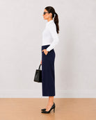 Bella navy blue medium waist 3/4th straight pants, side view with the mid calf hem