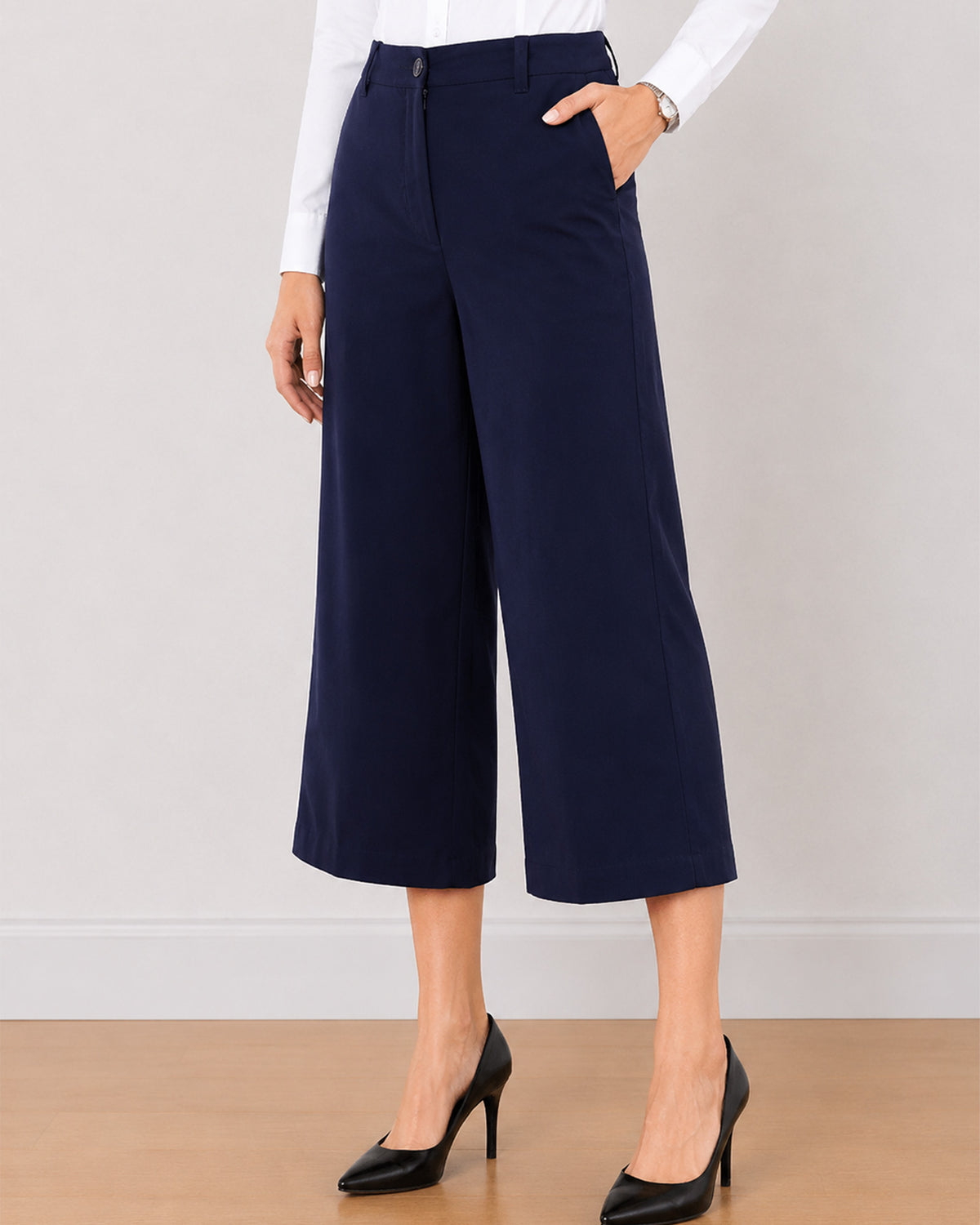 Bella navy blue medium waist pants front detail with a hand in the side cross pocket