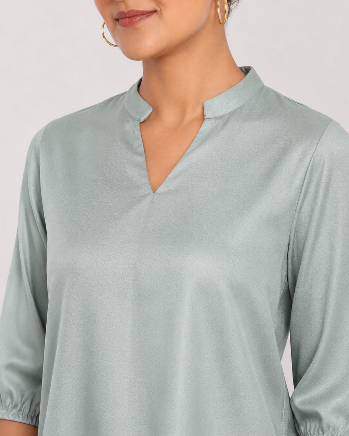 Bellina sage green 100% viscose top, close-up of the stand collar with V-neck