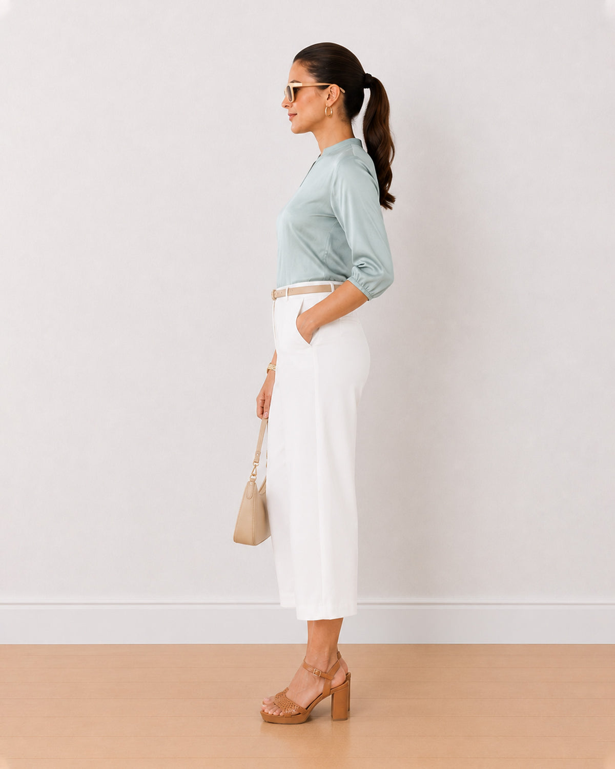 Bellina sage green viscose loose top side view with the long length and curved hem