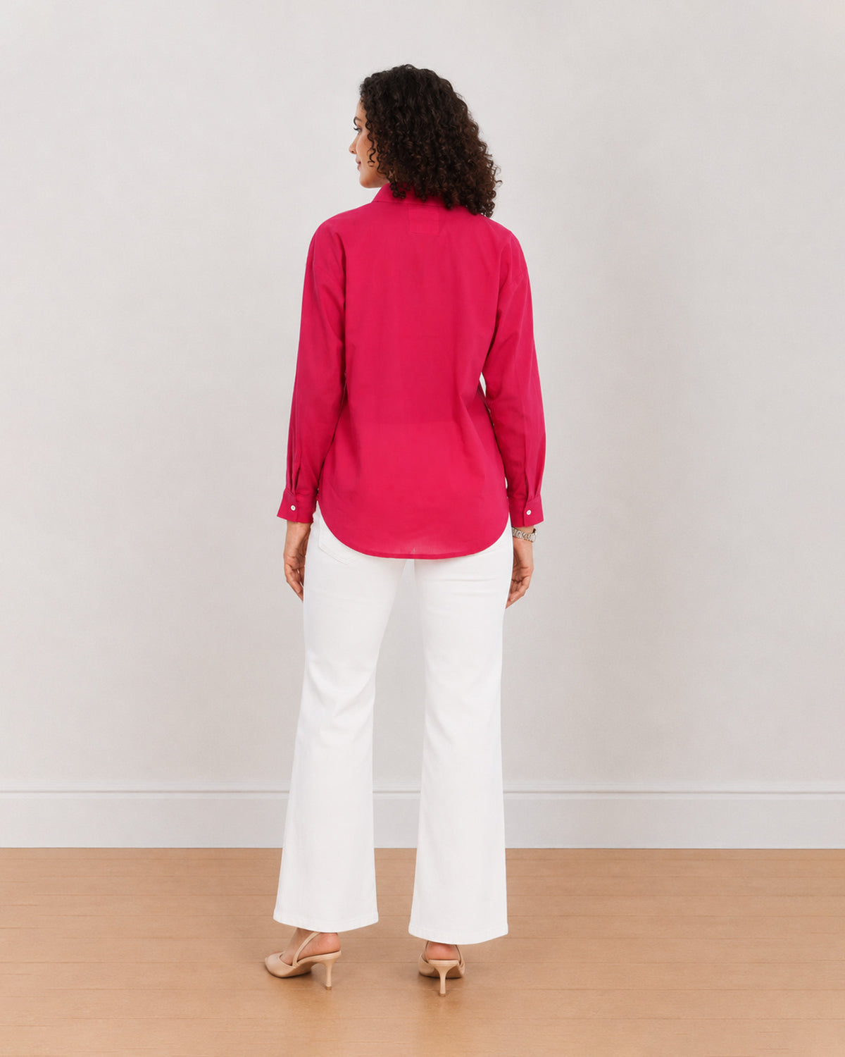 Berry bright pink cotton poplin shirt back view with the long curved hem