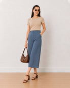 Bliss denim blue high waisted 3/4th straight pants, angled front view of the loose fit