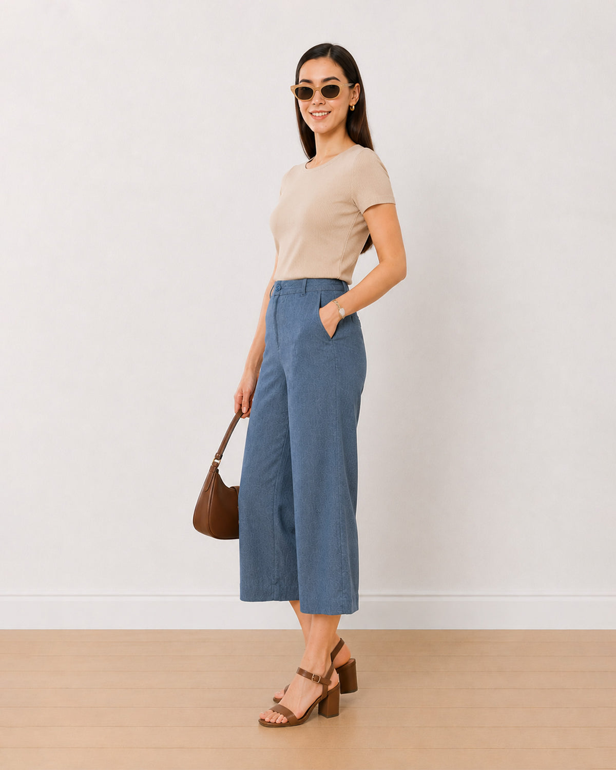 Bliss denim blue 3/4th straight pants, angled view with a hand in the side cross pocket