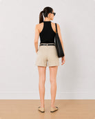 Bobby beige medium waist shorts back view with the mid thigh hem
