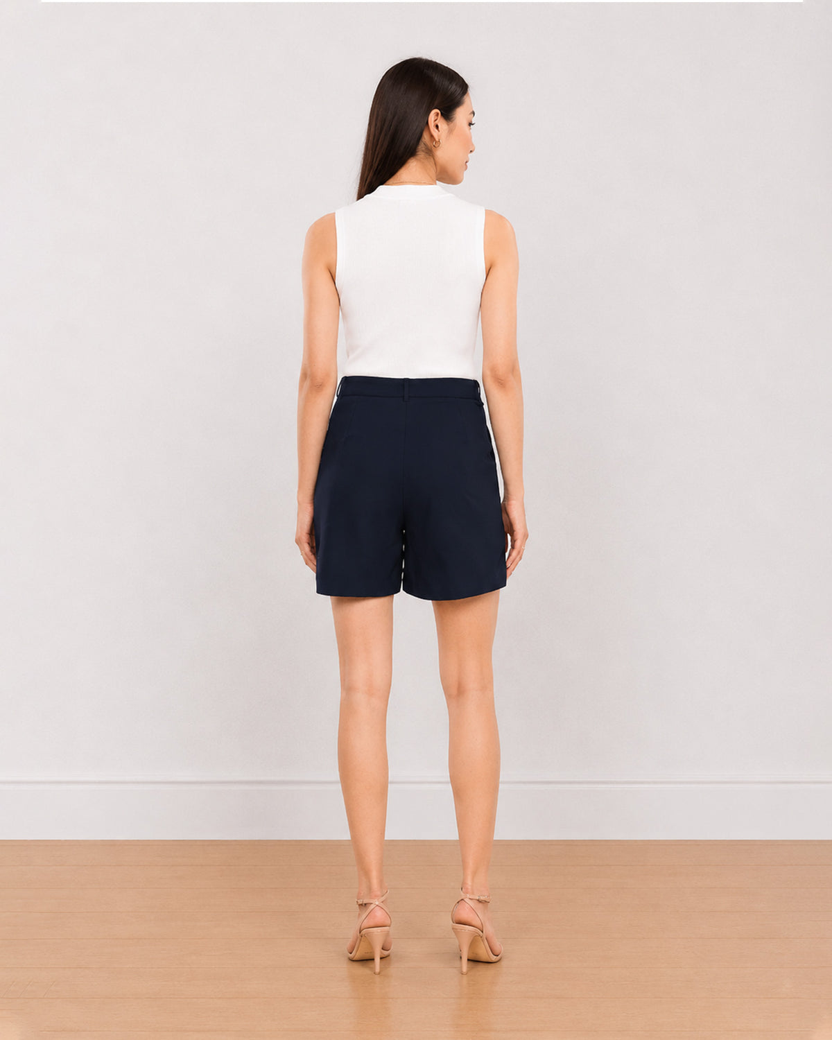 Bobby navy blue medium waist shorts back view with the mid thigh hem