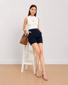 Bobby navy blue summer shorts, seated angled view of the medium waist loose fit