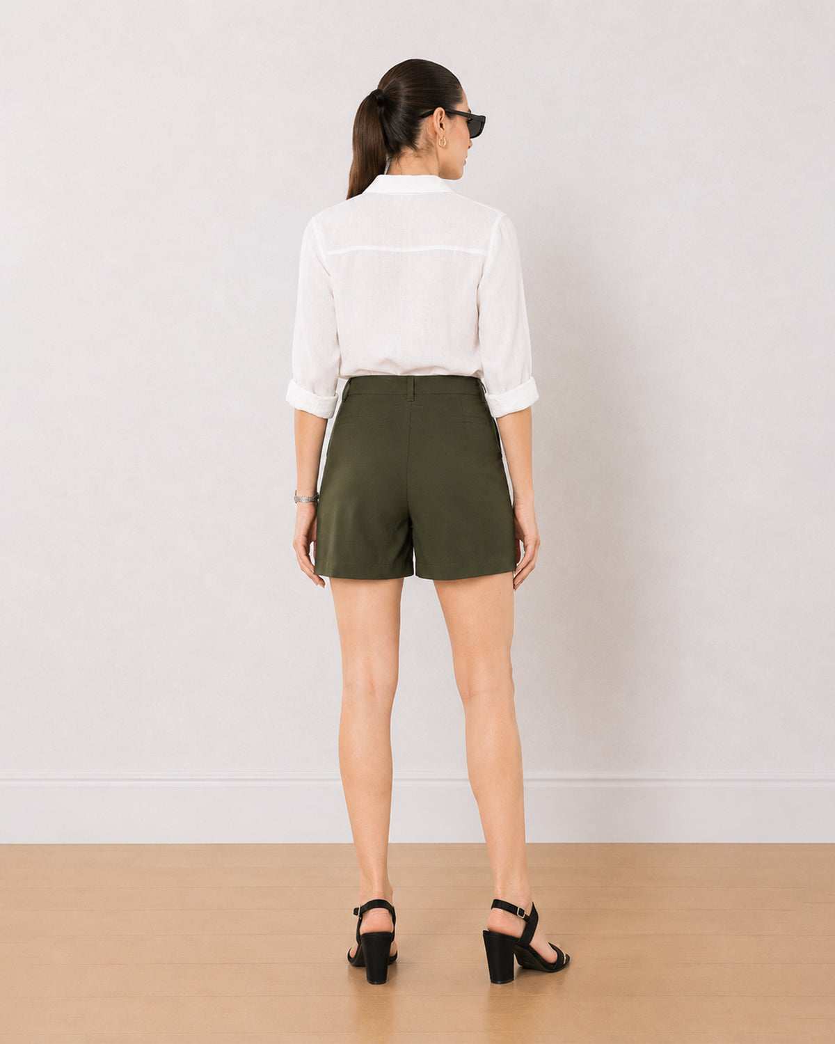 Bobby olive green medium waist shorts back view with the mid thigh hem