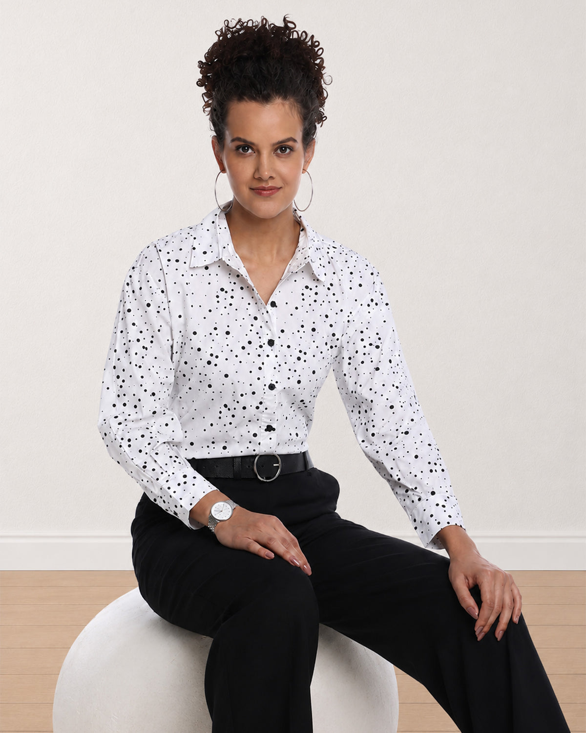Brenda black and white polka dots print shirt, seated waist up with the drop shoulder