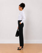 Brenda black and white polka dots shirt side view with the long curved hem