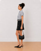 Bronze black and white striped oxford shirt side view with the curved hem and boxy fit
