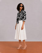 Brooke black and white abstract print shirt, angled front view with the curved hem